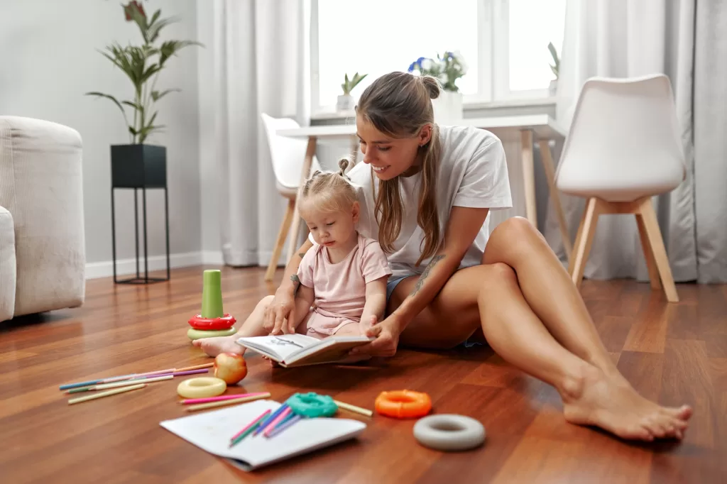 A Mother and Her Child Enjoying a Delightful Storytime Together in the Comfort of Their Home