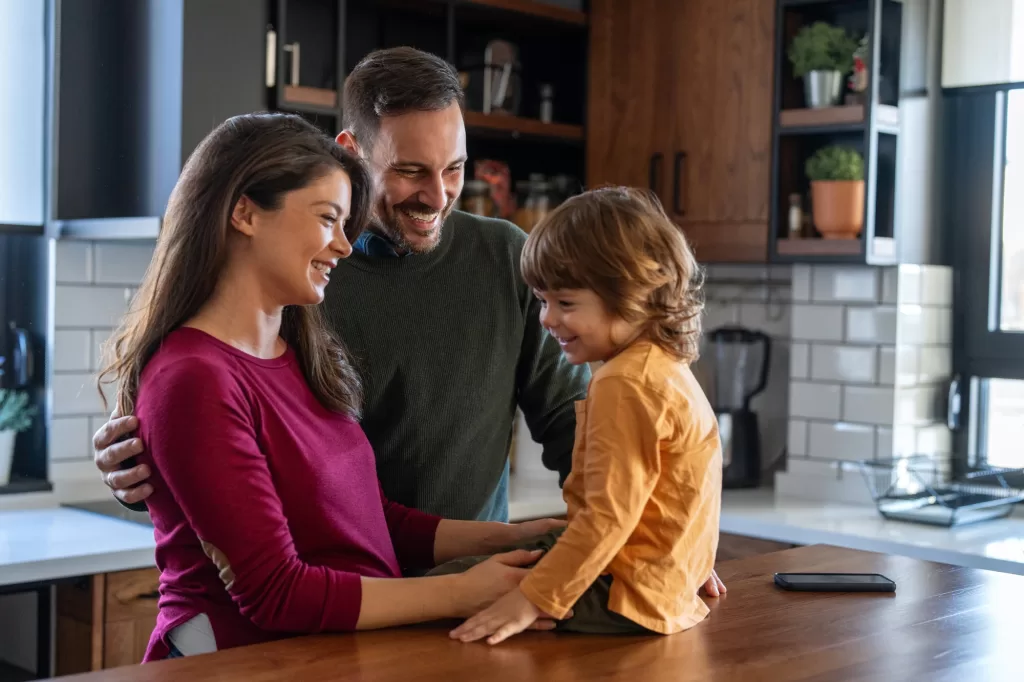 Happy family having fun in the kitchen, spending quality time together during weekend.